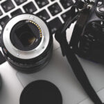 Digital camera, lens and laptop. concept of photographer work station.